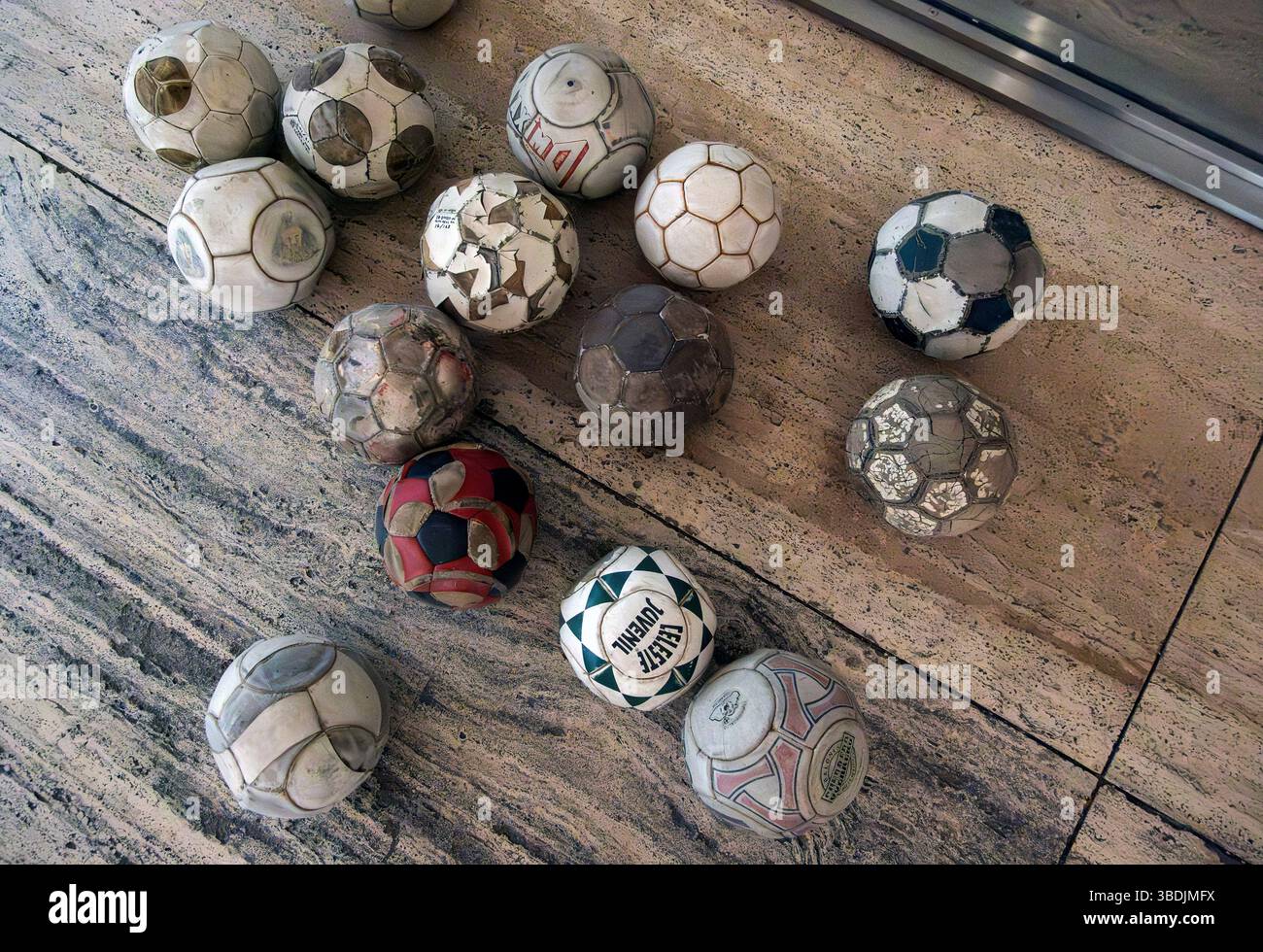 Vintage leather soccer balls in art installation by Mexican artist Gabriel Orozco  in the Jumex Museum, Mexico City, Mexico Stock Photo