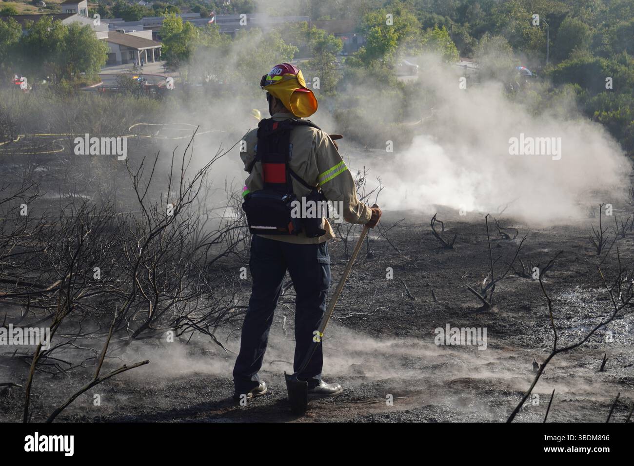 Firefighters contain the fire on the mountains. A brush fire broke out ...