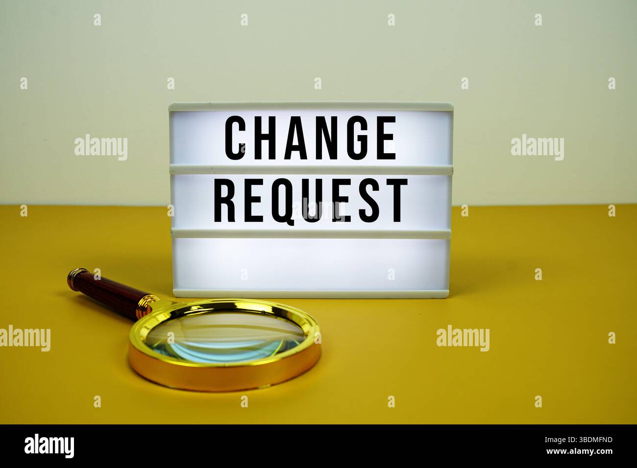 Change Request text on LED lightbox with magnifying glass on yellow background Stock Photo