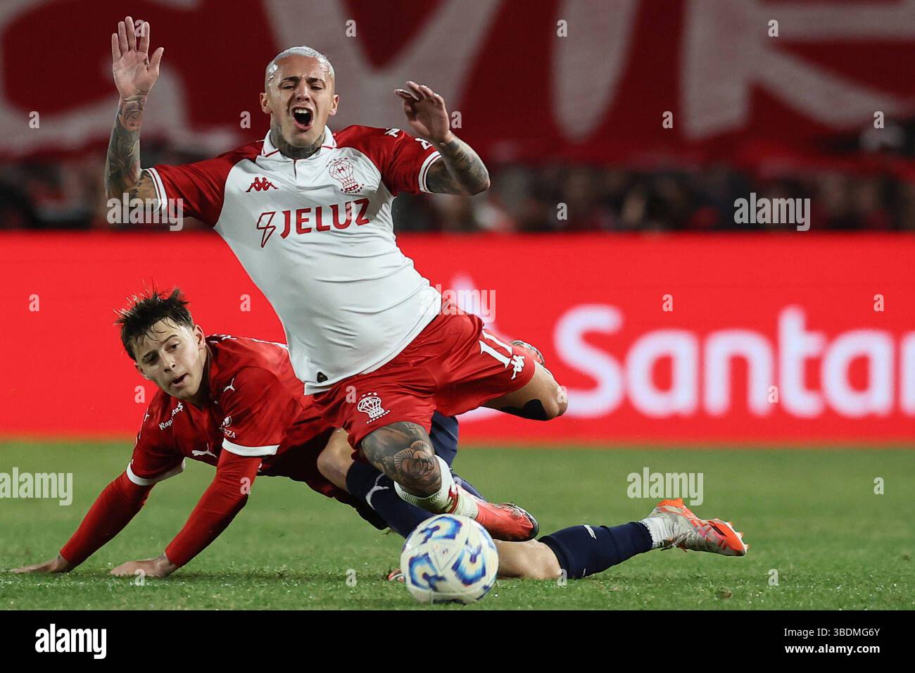 Huracan s forward Agustin Urzi front is fouled by Independiente s