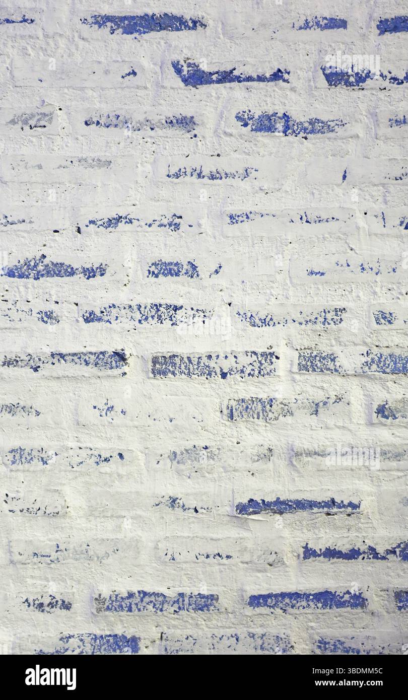 Front View of Grunge Painted White and Blue Brick Wall Stock Photo
