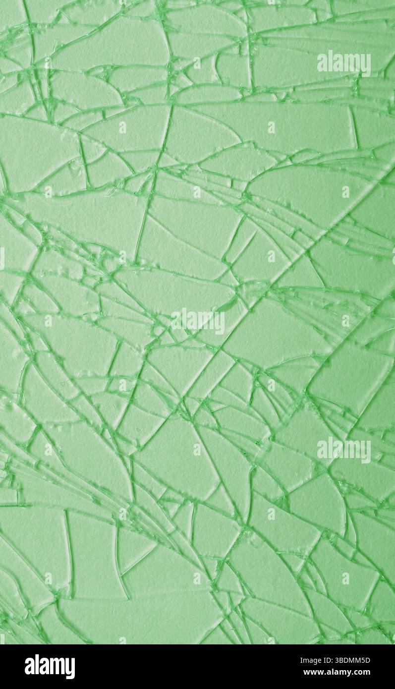 Artistic pattern of light green cracked glass surface Stock Photo