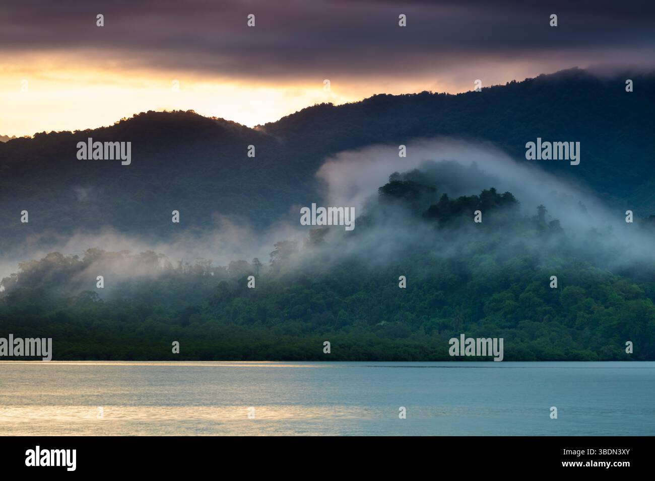 Sunrise and misty rainforests and mountains seen from the island Bahia ...