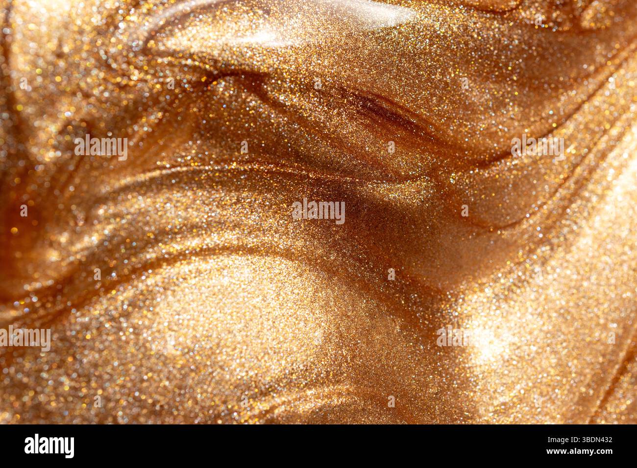 Glowing golden shimmering cosmetic texture of gel or body spray ...