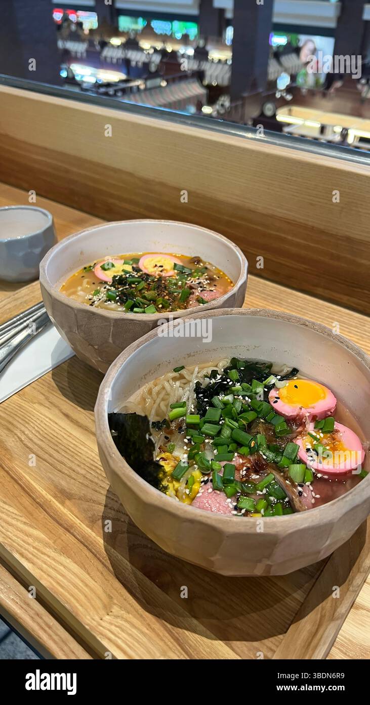 Two ramen soups in a cafe. Soup with seafood and herbs. Delicacy.  Japanese cuisine. - Smartphone Captured Stock Image
