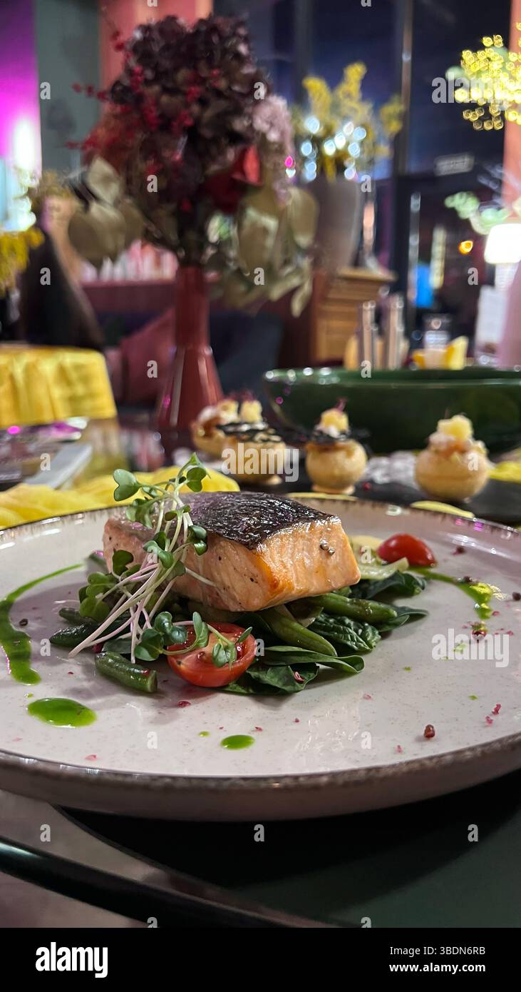 Baked salmon with asparagus. Dishes in a restaurant. Atmosphere of luxury. Dinner. Romance. - Smartphone Captured Stock Image
