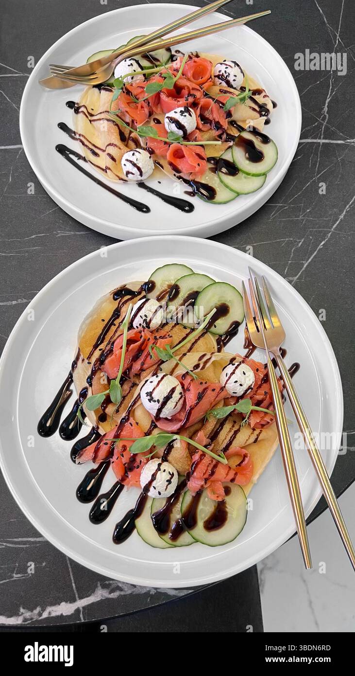 Pancakes with salmon. Red fish. A dish for breakfast in a restaurant. Delicious. - Smartphone Captured Stock Image