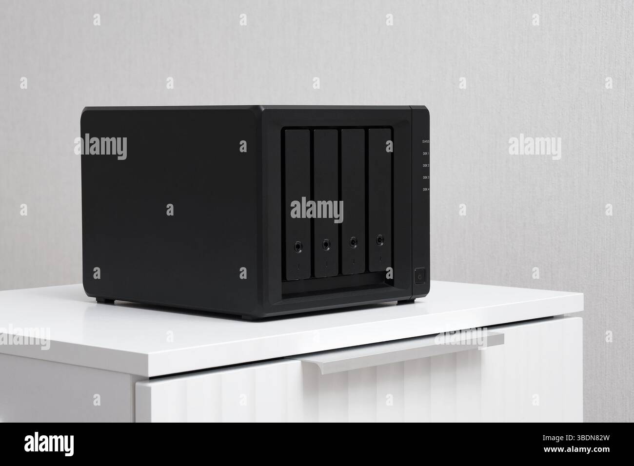 NAS server. Network storage. Device for backing up important information on a white bedside table. For home or office. Stock Photo