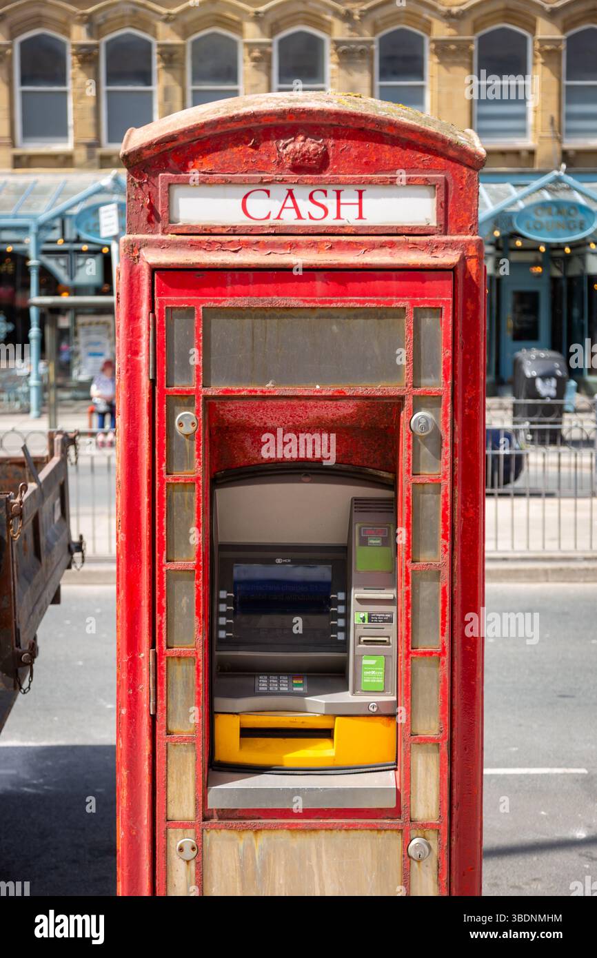 Cashpoint ATM in a converted red telephone box, Llandudno, Wales. UK. 2025 Stock Photo