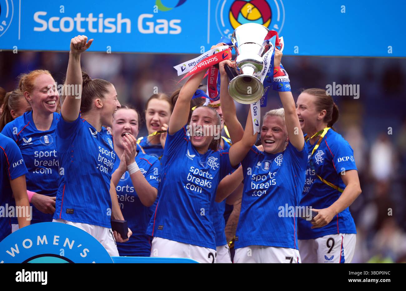 Rangers' Brogan Hay (right) with the trophy, celebrates with team mates ...