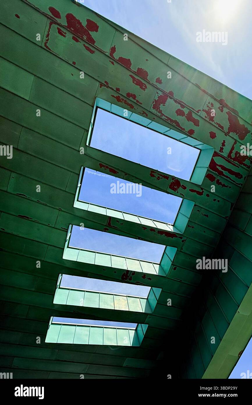 Abstract of canopy roof of Bolton One (part of University of Greater Manchester) against a blue sky - Smartphone Captured Stock Image