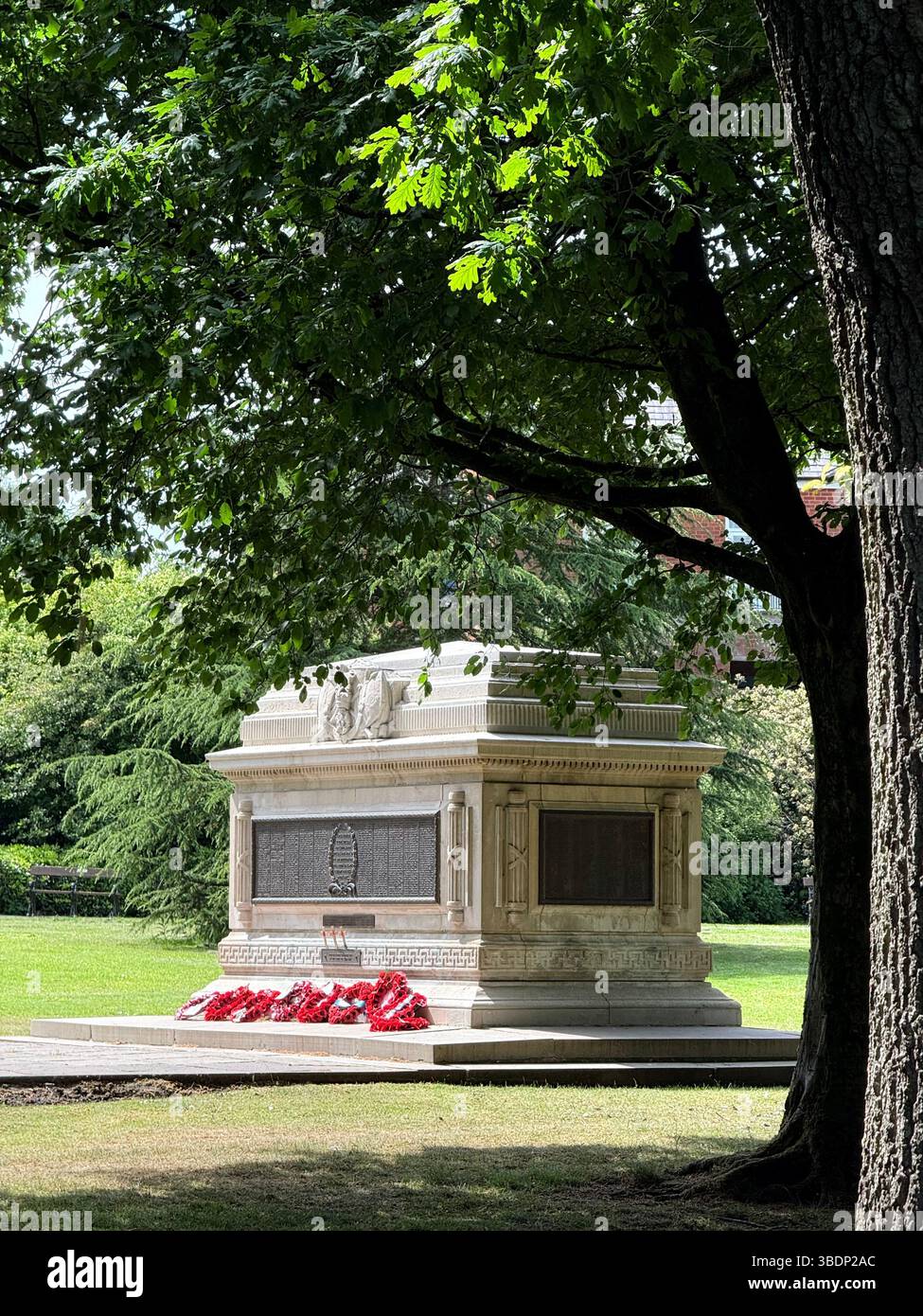 War memorial (cenotaph) and poppy wreaths in Queens Park in Bolton town centre - Smartphone Captured Stock Image