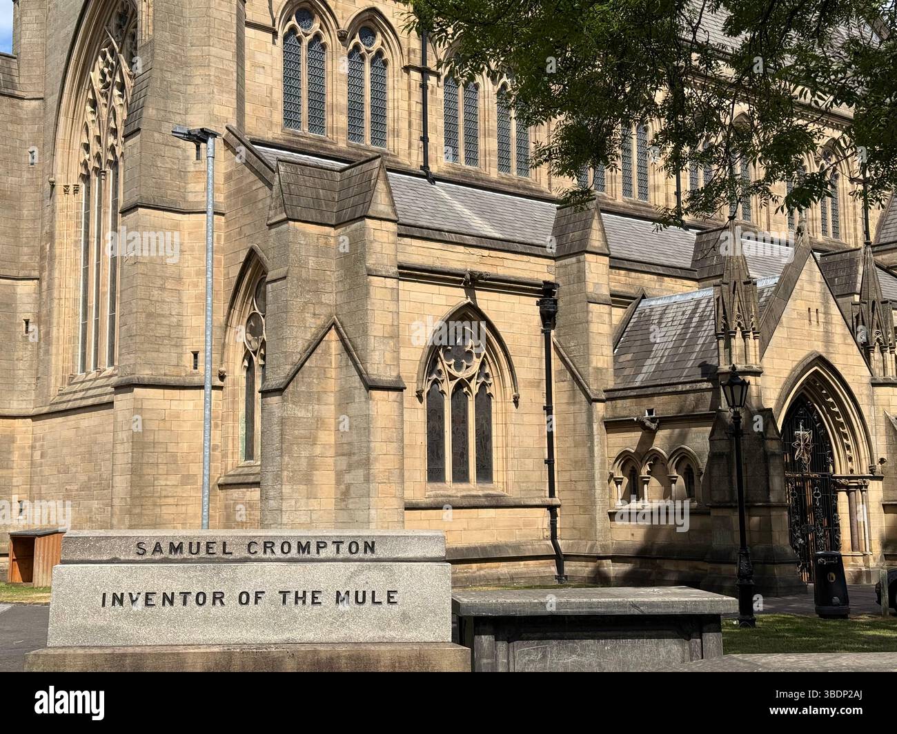 Tomb of Samuel Crompton (inventor of the Mule) in graveyard of Bolton parish church. St Peter’s church in background - Smartphone Captured Stock Image