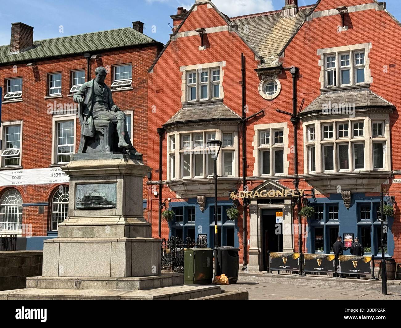 Statue of Samuel Crompton (inventor of the mule) and Dragonfly pub in Nelson Square in Bolton town centre - Smartphone Captured Stock Image
