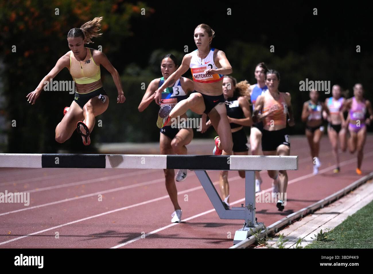 Kaylee Mitchell Elise Crawford (GBR), left, and Kaylee Mitchell (GER) hurdle a barrier ...