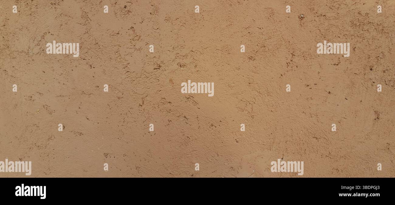 Rough concrete wall texture with a light brown color, perfect for backgrounds and providing ample copy space Stock Photo