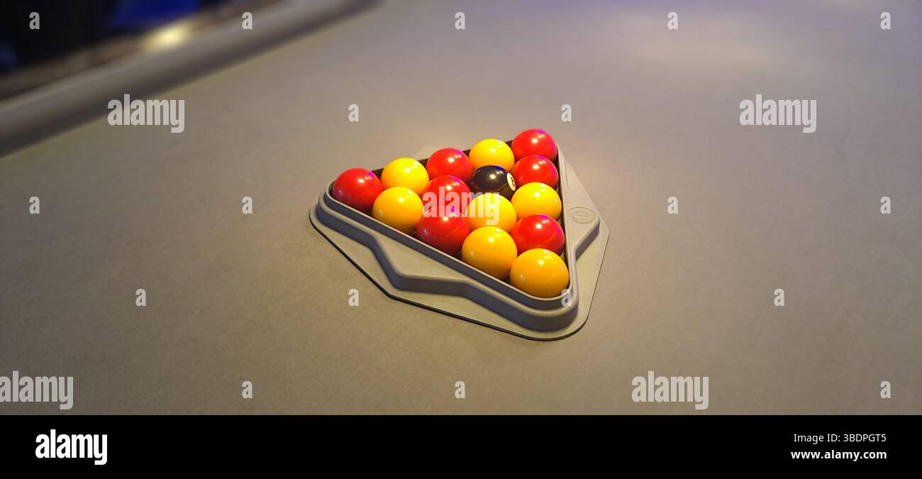 Billiard balls arranged in a triangle on a pool table Stock Photo