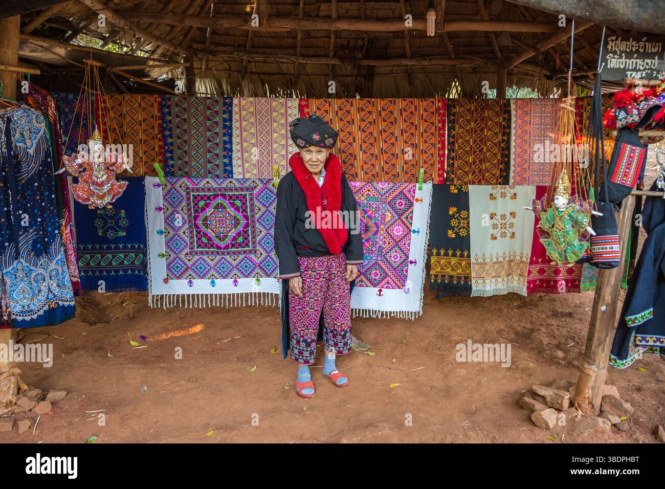Traditionally dressed woman selling hand woven items in the Lu Mien-Yao ...