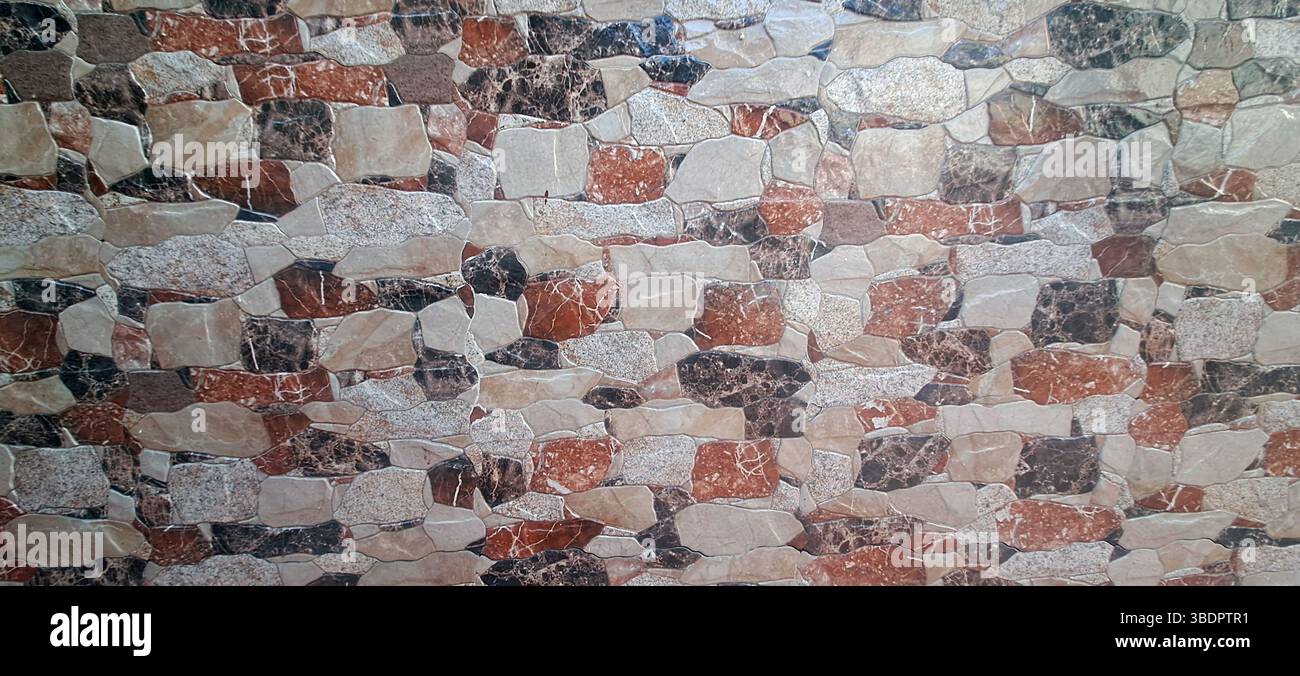 Multicolored stone cladding tiles forming a textured wall, perfect for rustic interior or exterior design projects Stock Photo