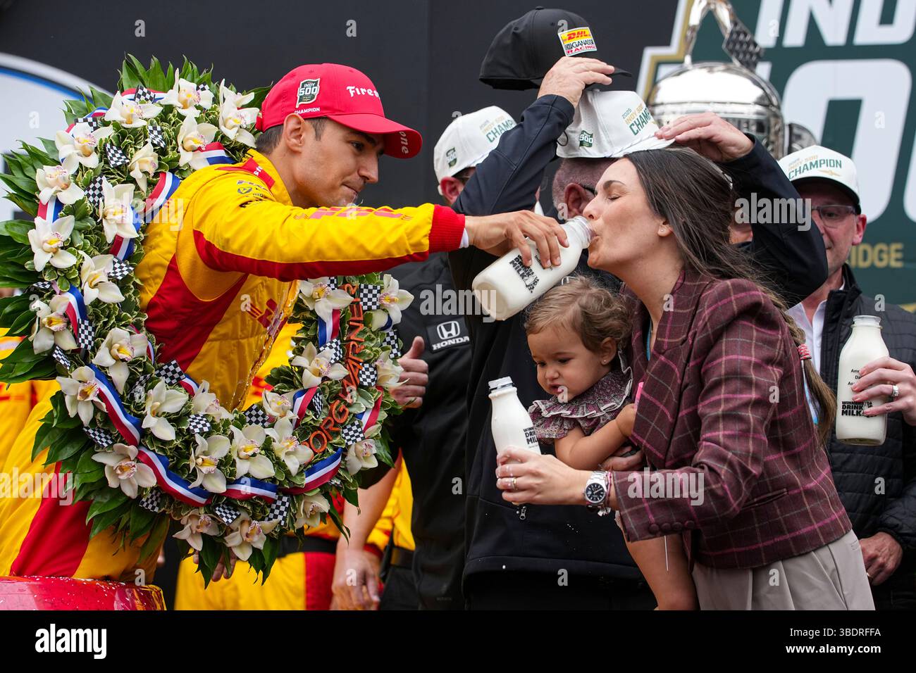 Alex Palou, of Spain, gives his wife Esther Valle, a talk of the ...