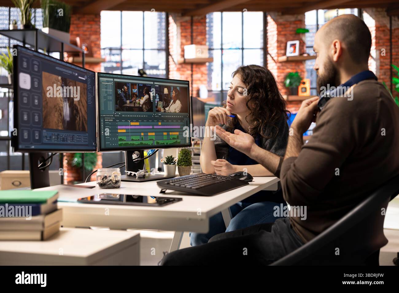 Creative couple working together on video editing software for movie ...