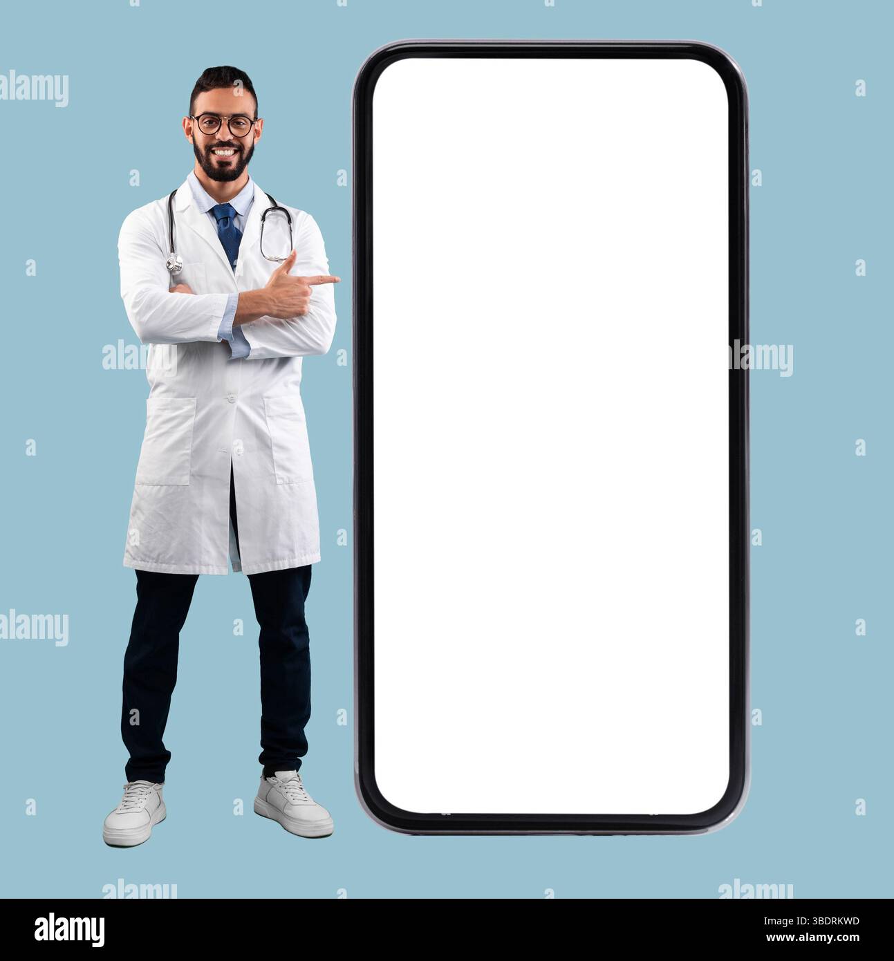 Doctor pointing at big white empty smartphone screen, mock-up Stock Photo
