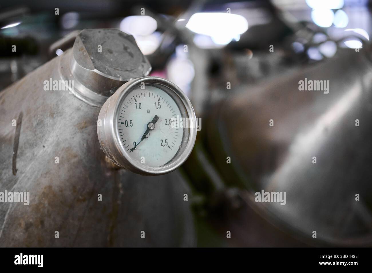 Detailed view of a vintage pressure gauge in an industrial setting ...