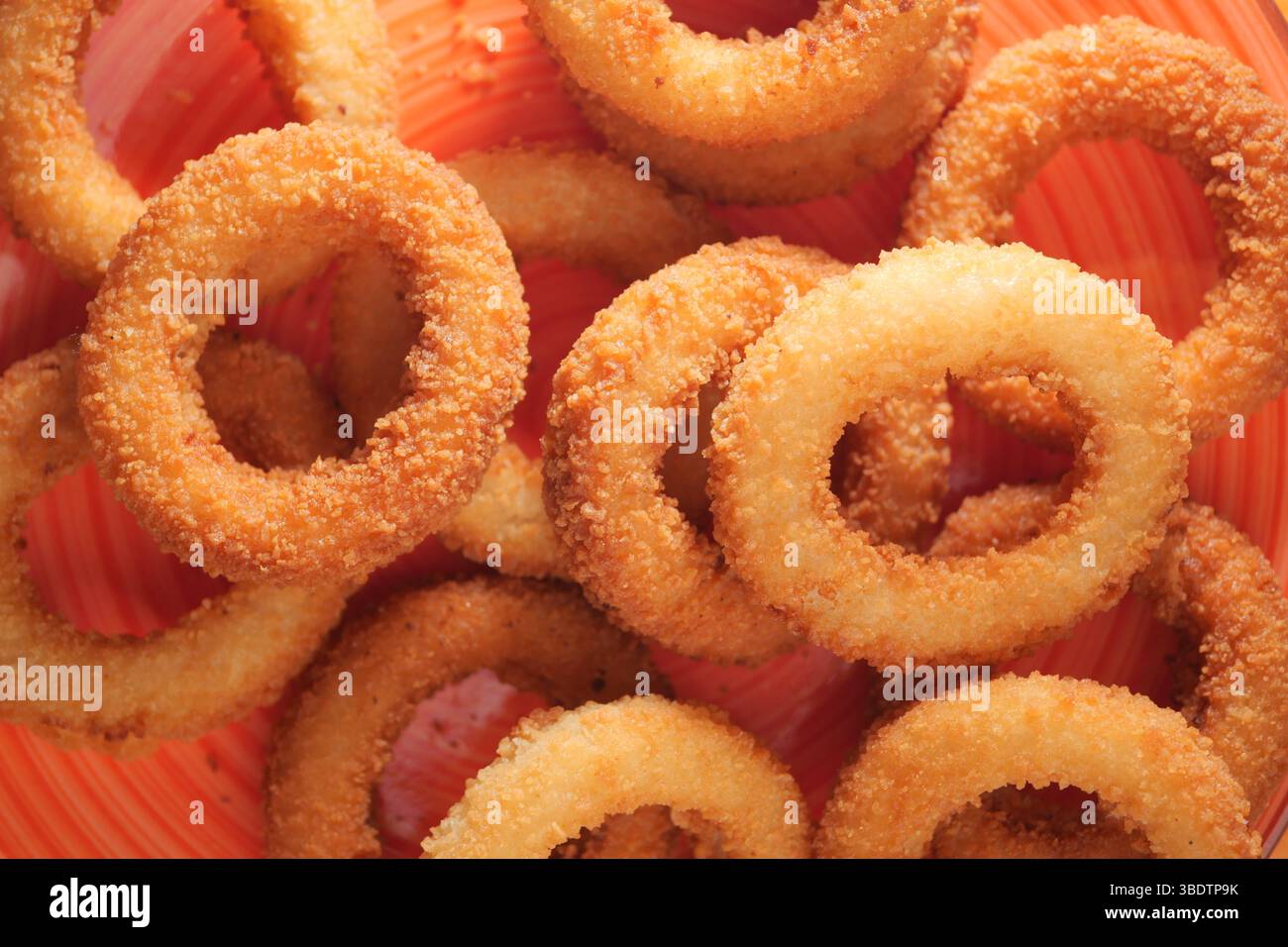 Crispy onion rings served in a vibrant bowl Stock Photo - Alamy