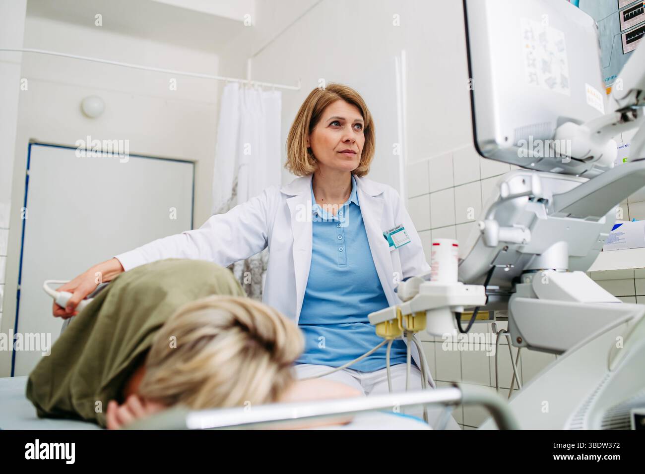 Medical examination with ultrasound probe on lower back Stock Photo - Alamy