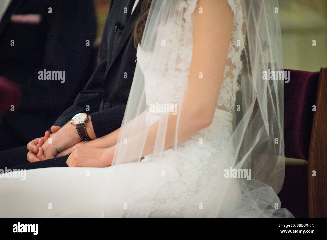 Bride and Groom Holding Hands During Ceremony Stock Photo