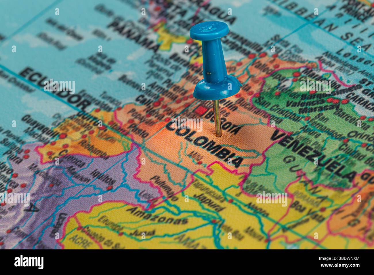 A blue pin marks Colombia on a colorful map of South America ...