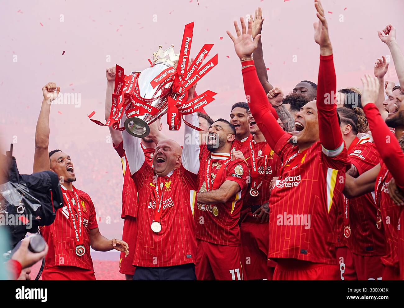 Liverpool manager Arne Slot lifts the Premier League trophy with the ...