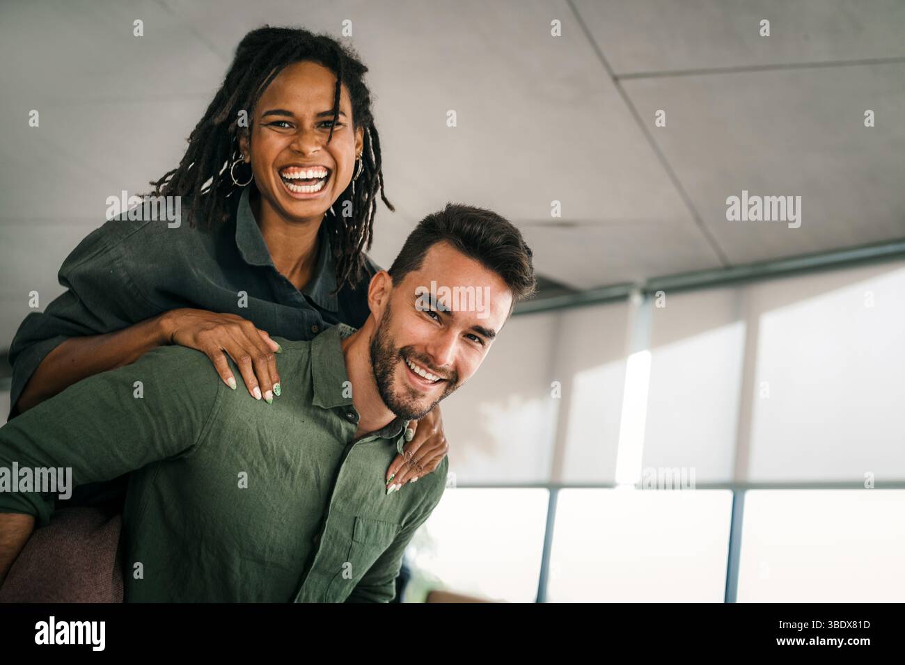 Cheerful diverse coworkers having fun during work break using technology enjoying working together Stock Photo
