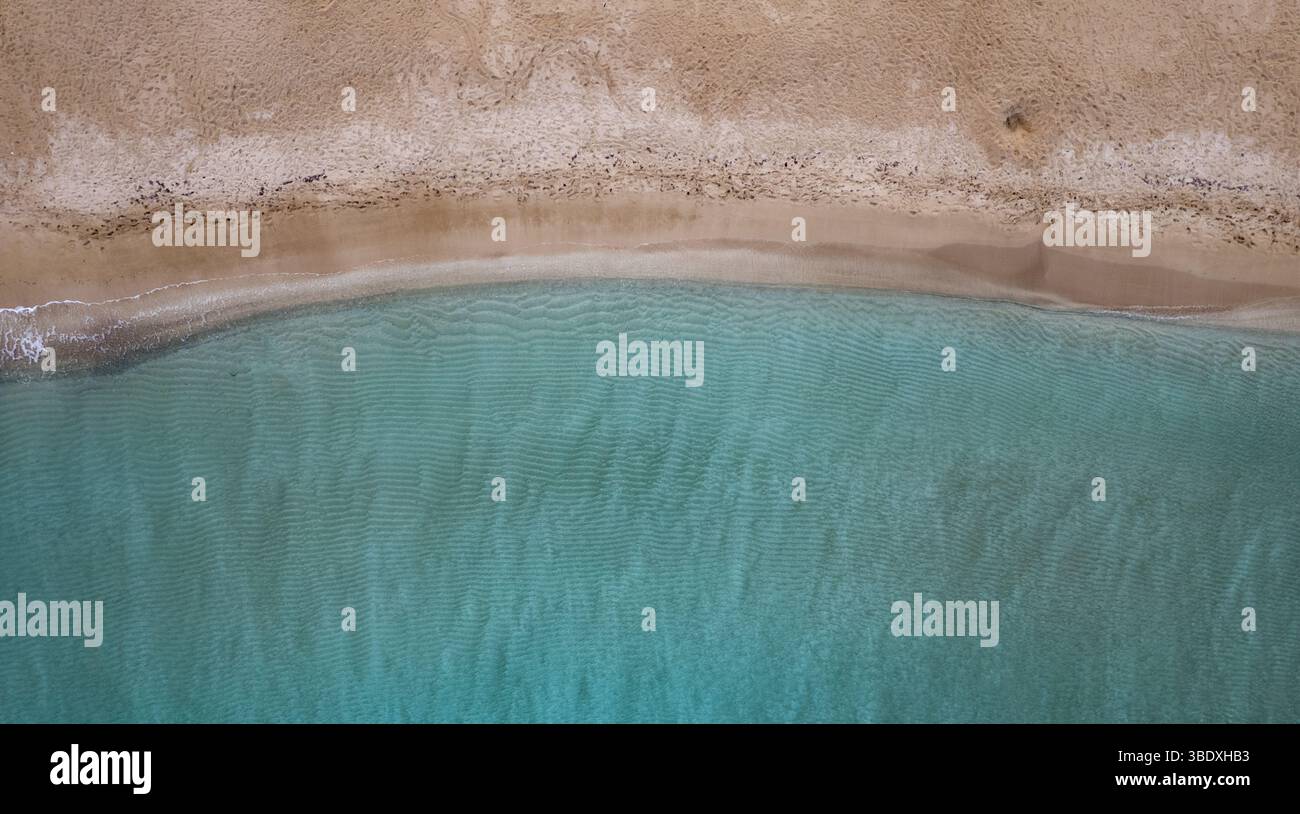 Clean ocean waves in the tropical summer sandy beach. Aerial view of empty tropical beach. Stock Photo