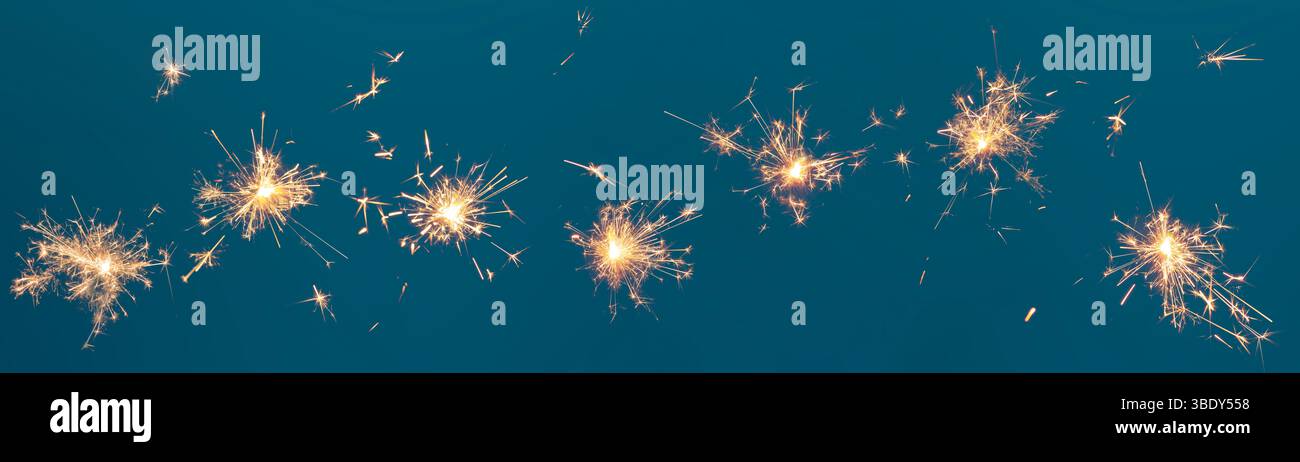 Burning sparklers collection on blue background, abstract banner Stock Photo