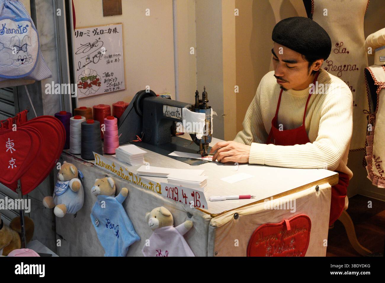 Tailor working on a sewing machine in the Asakusa district of Tokyo,Japan,Asia. Stock Photo