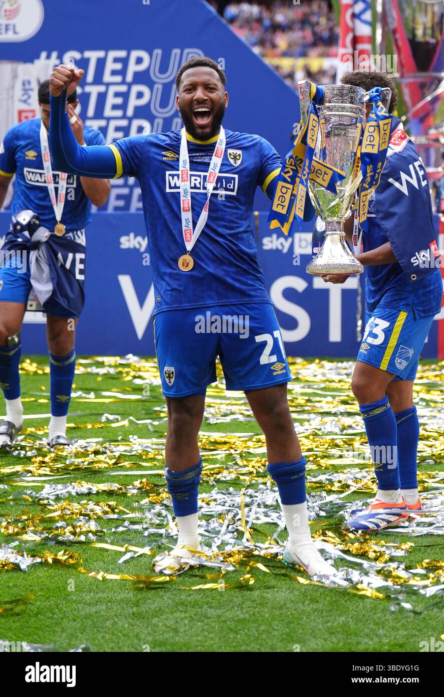 AFC Wimbledon s Myles Hippolyte Celebrates With The Trophy During The 