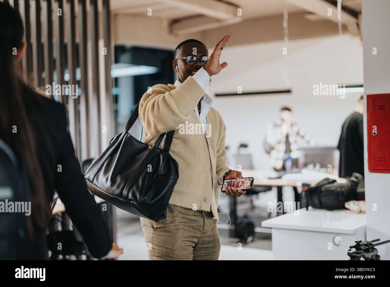 Casual greeting between colleagues in a modern office environment Stock Photo