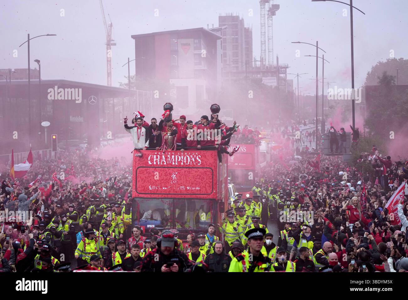 liverpool-players-celebrate-with-the-trophy-on-an-open-top-bus-during