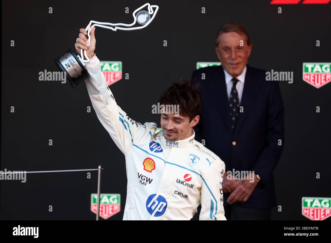 Charles Leclerc of Scuderia Ferrari celebrates on the podium during the ...