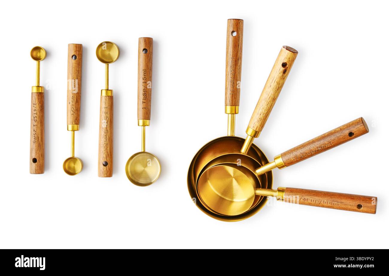 Golden measuring spoons with wooden handles isolated on white background Stock Photo