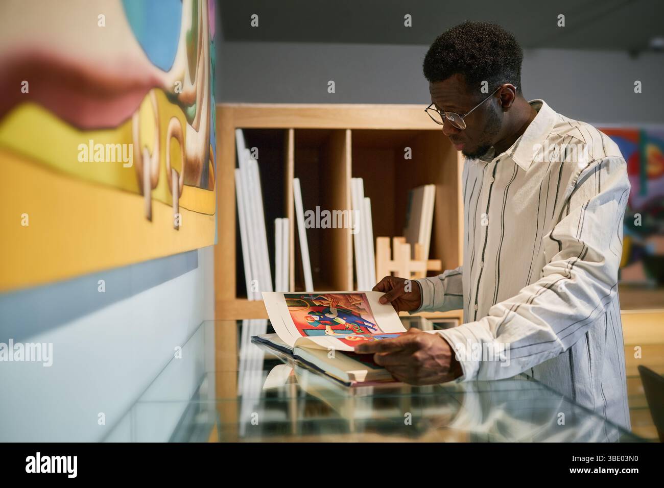Analyzing Art Book in Gallery Setting Stock Photo - Alamy