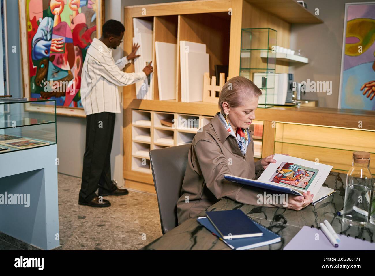 Analyzing Artwork in Modern Art Studio Setting Stock Photo - Alamy