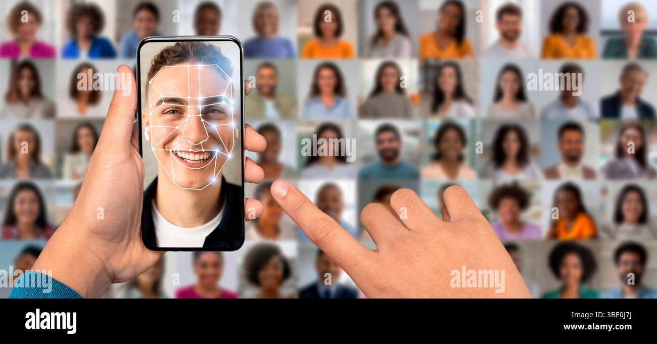 A person holds a smartphone displaying face recognition technology Stock Photo
