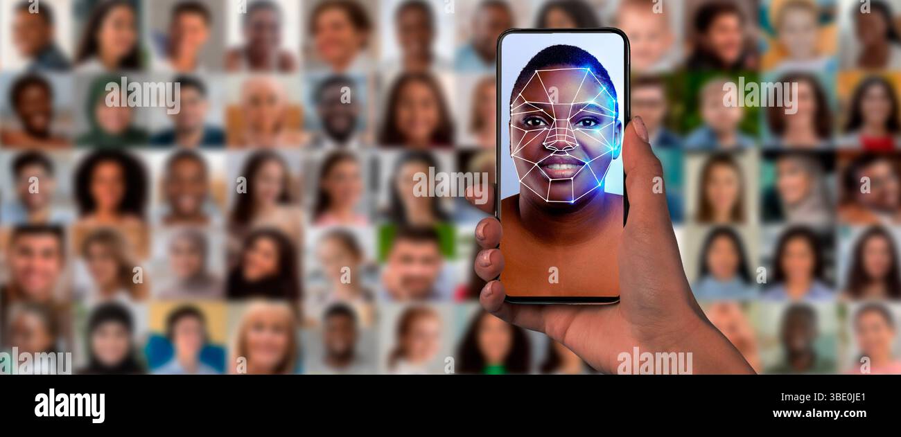 A hand holds a smartphone displaying a digital face scan Stock Photo