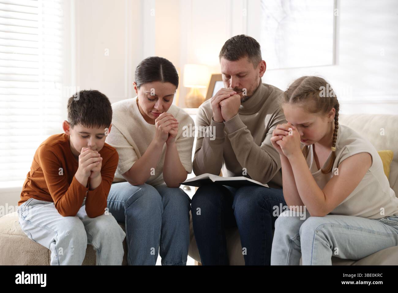 Kid praying with adult hi-res stock photography and images - Alamy