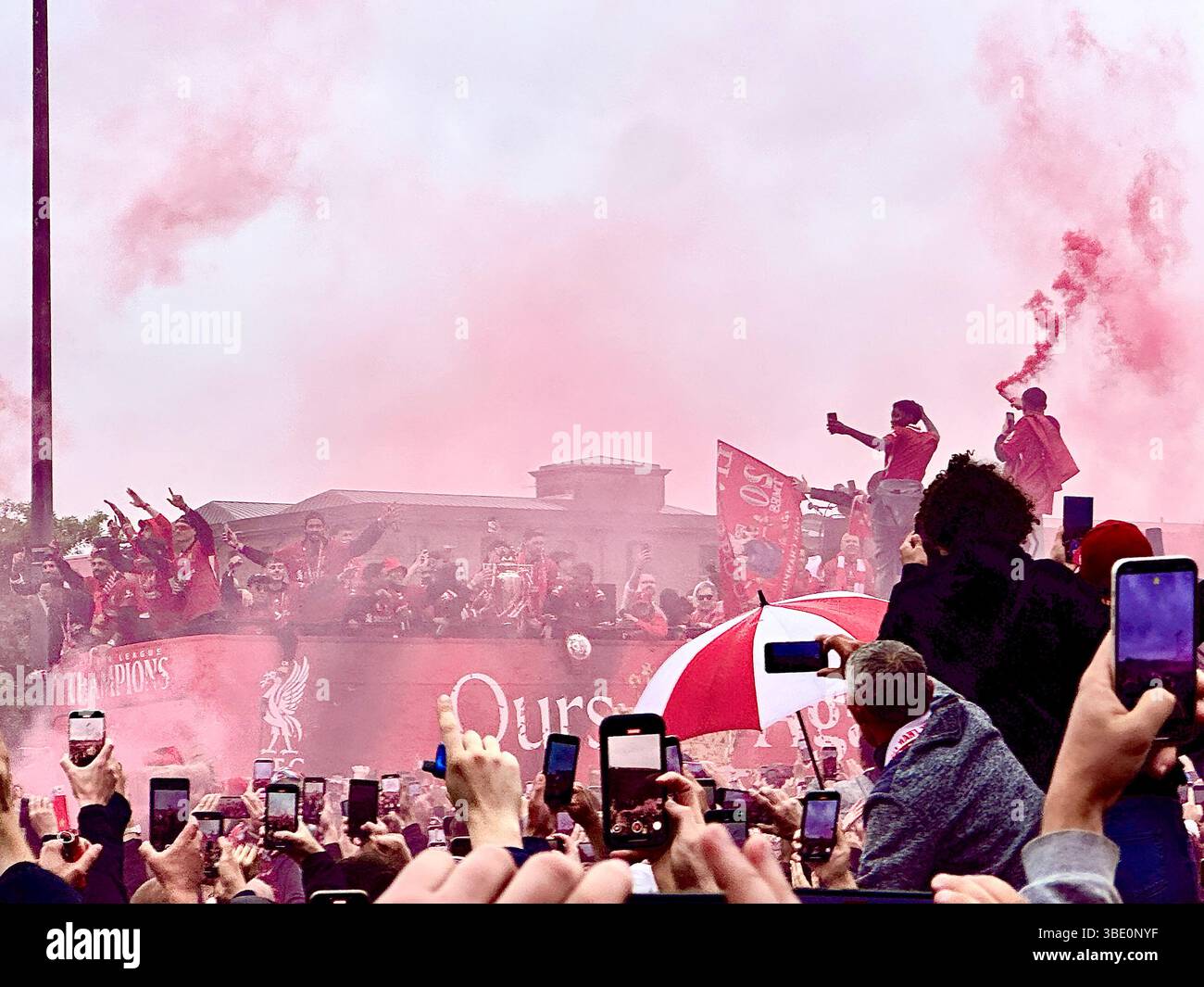 Liverpool’s open-top bus arrives on The Strand, fans cheer and film. Salah, Núñez, Endo and Alisson celebrate with the FA Cup, Liverpool, UK, 26 May - Smartphone Captured Stock Image