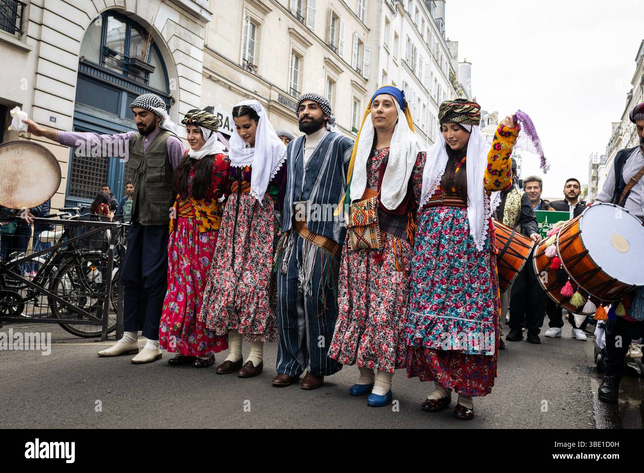 Kurdish people, dressed in the traditional clothing, dance during the ...