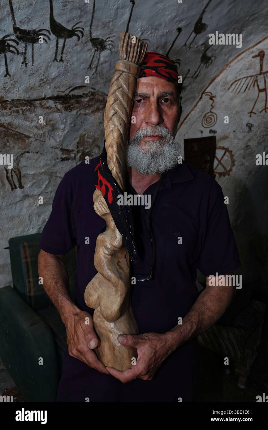 Arab sculptor Akram Saffan is seen with a work depicting Kurdish women ...