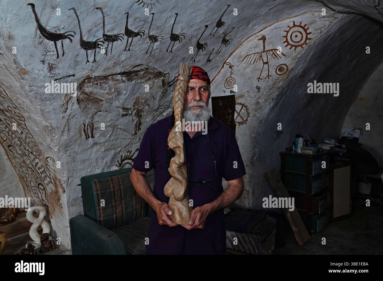 Arab sculptor Akram Saffan is seen with a work depicting Kurdish women ...